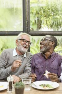 Two male friends enjoying lunch together